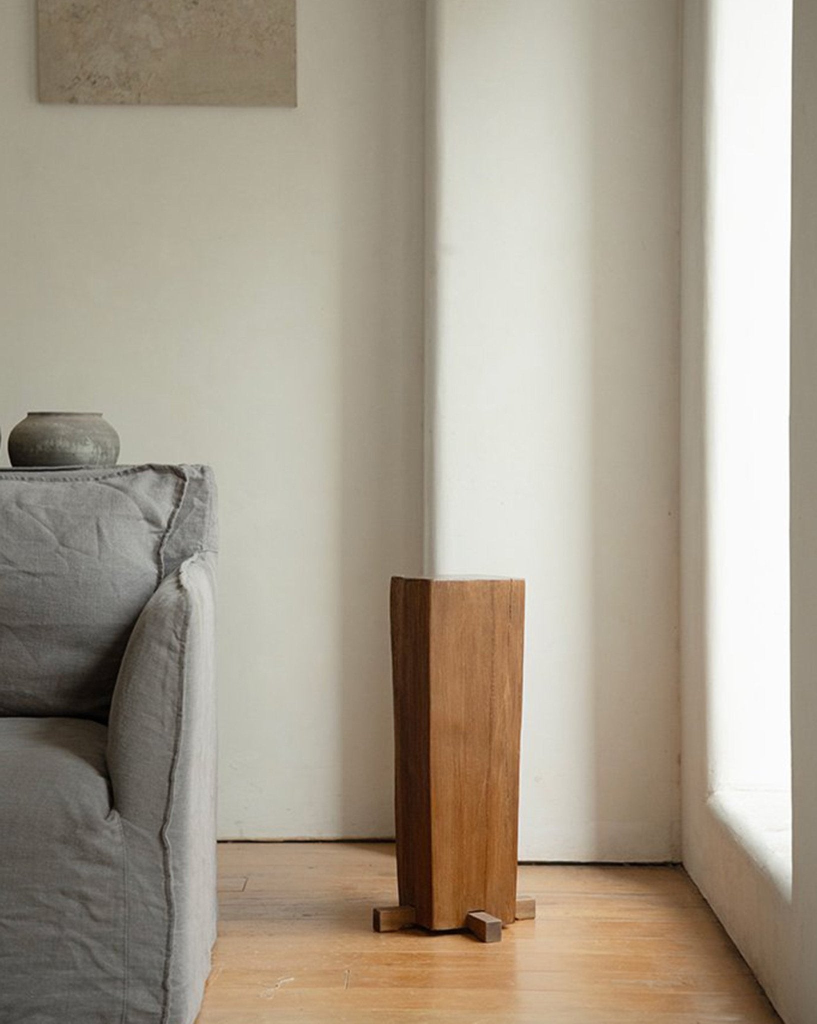 Rustic wooden pedestal, organic interior design, showcasing natural wood texture, timeless simplicity