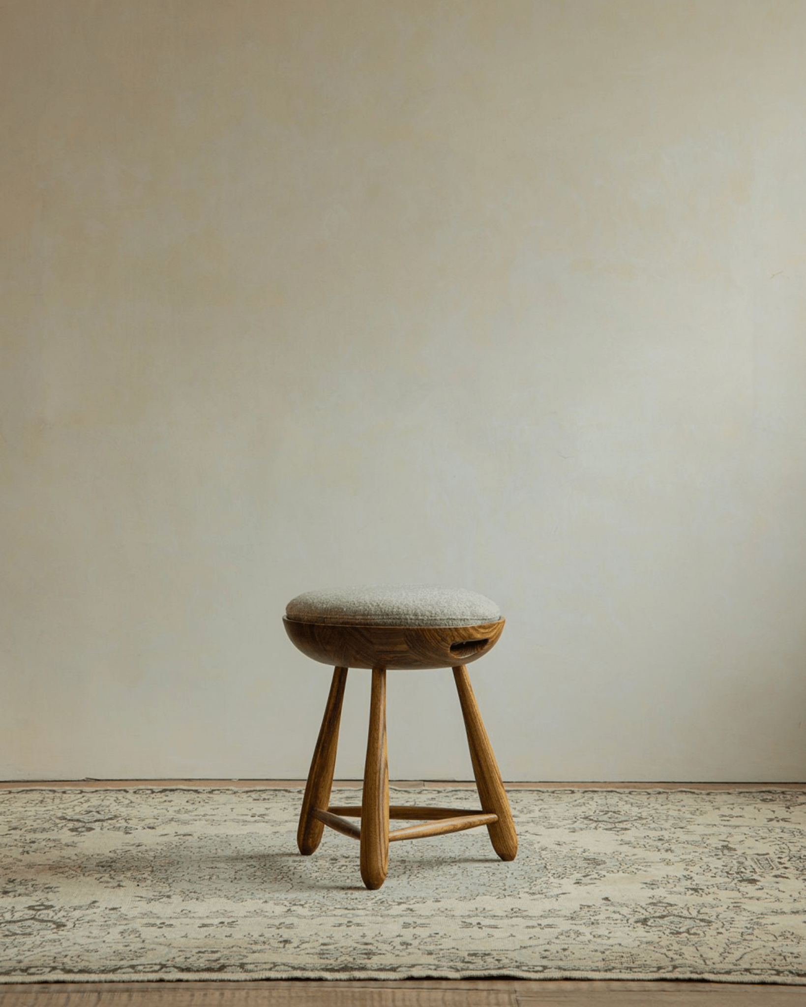 Zebrawood Mocho Stool with gray cushion and organic design, ideal for modern living spaces.