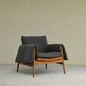 Teak wood garden lounge chair with dark gray cushion and blanket, perfect for indoor and outdoor use