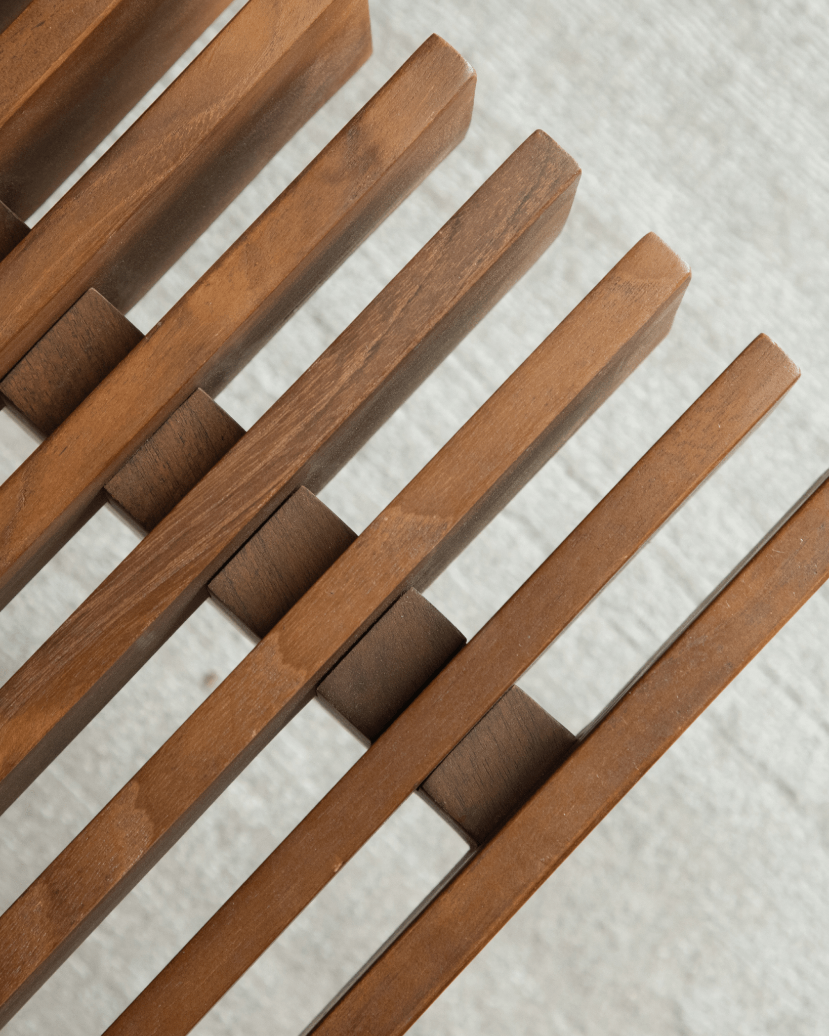 Close-up of Riva Coffee Table's solid teak wood slatted design, showcasing modern organic style and craftsmanship.