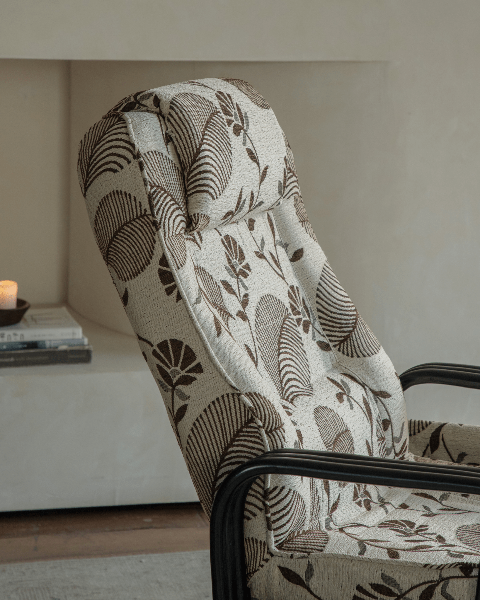 Willow Rattan Chair with floral patterned cushion, black frame, and high back for added comfort.