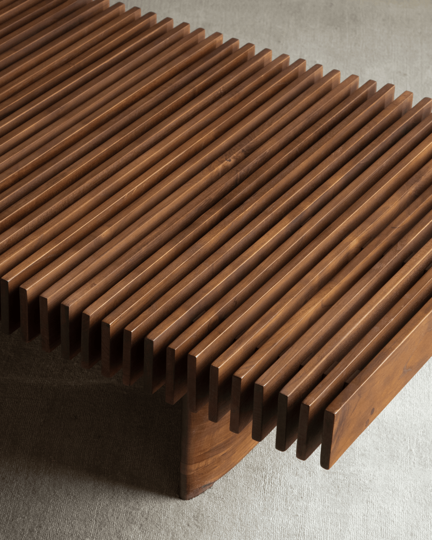 Close-up of Riva Coffee Table's solid teak wood slatted design, showcasing modern organic style