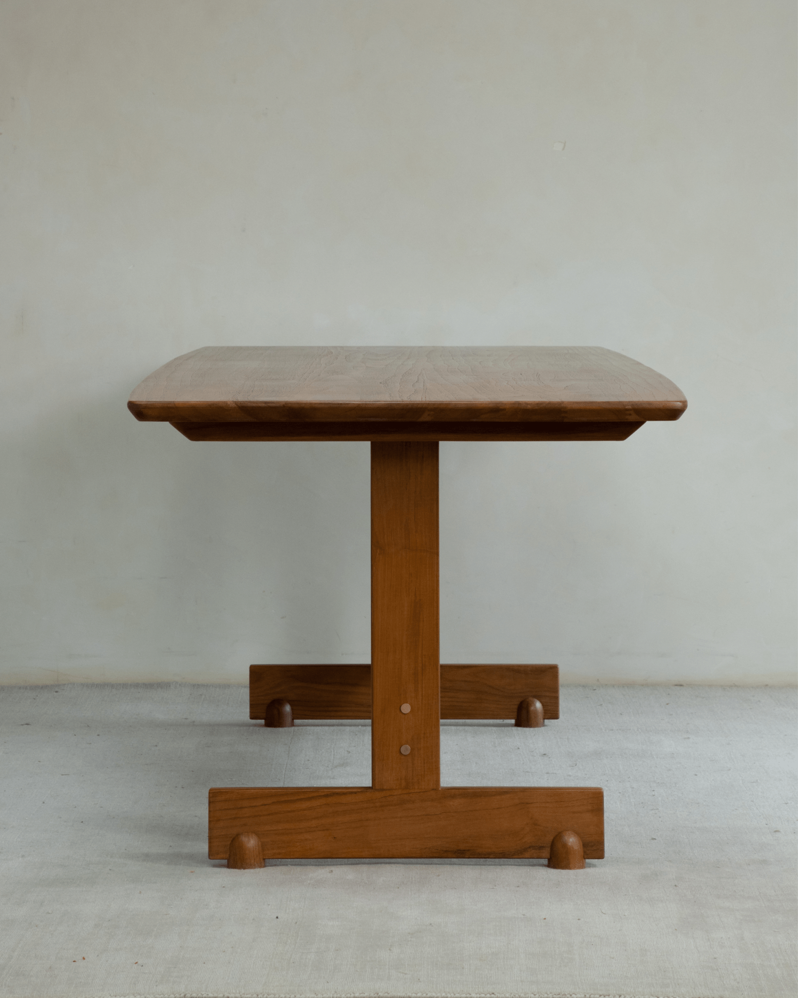 Hoof Dining Table, solid wood I-shaped base, warm brown finish, stable design, versatile for dining.