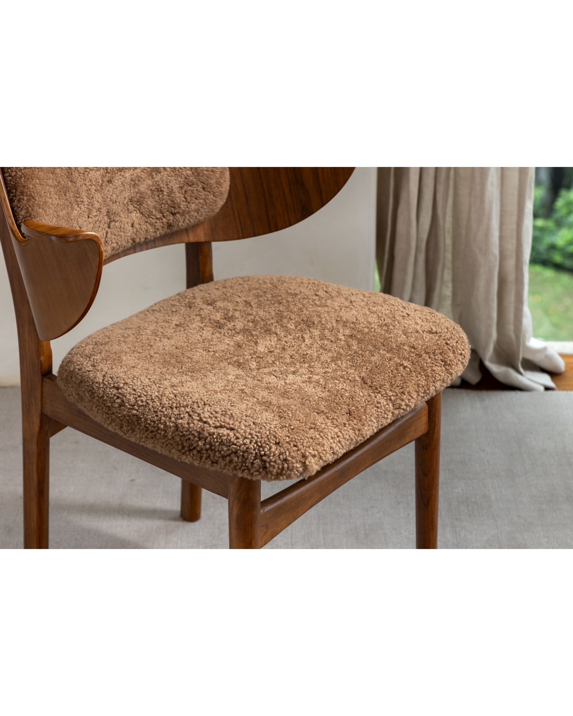 Maren Chair in beige with natural wood frame and textured lambswool upholstery.