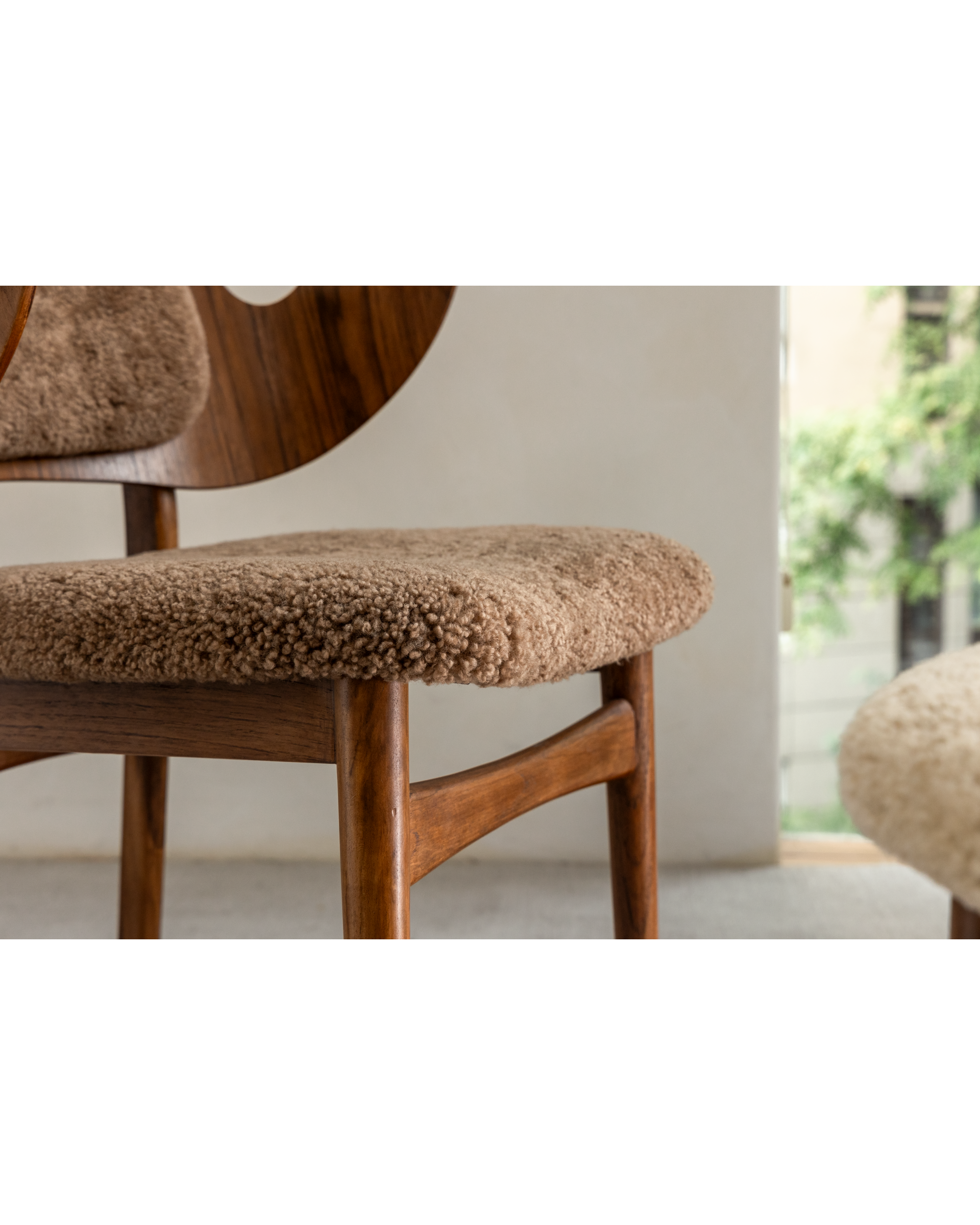 Maren Chair with beige lambswool seat and teak wood frame.
