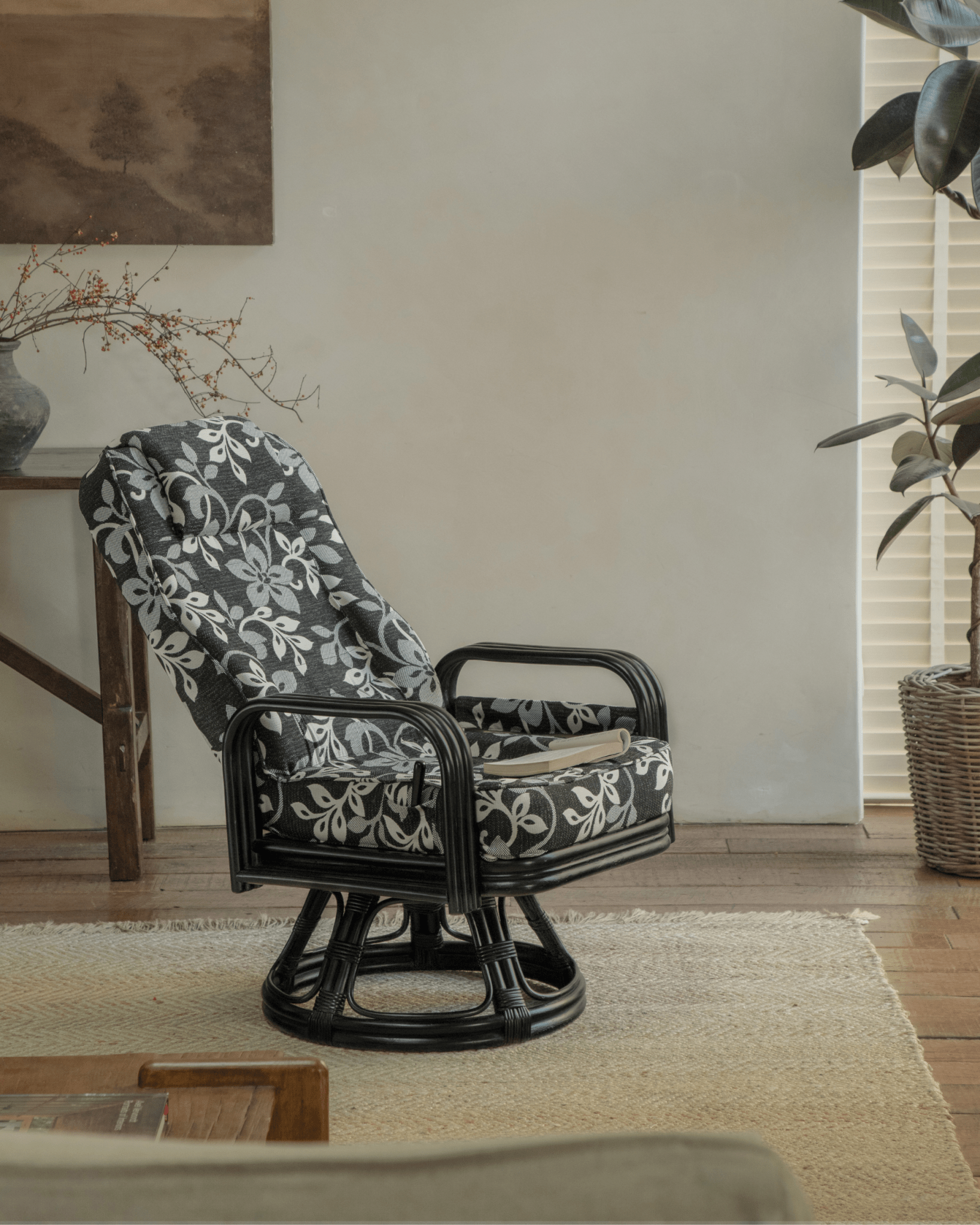 Willow Rattan Chair with floral cushion, black rattan frame, and modern design
