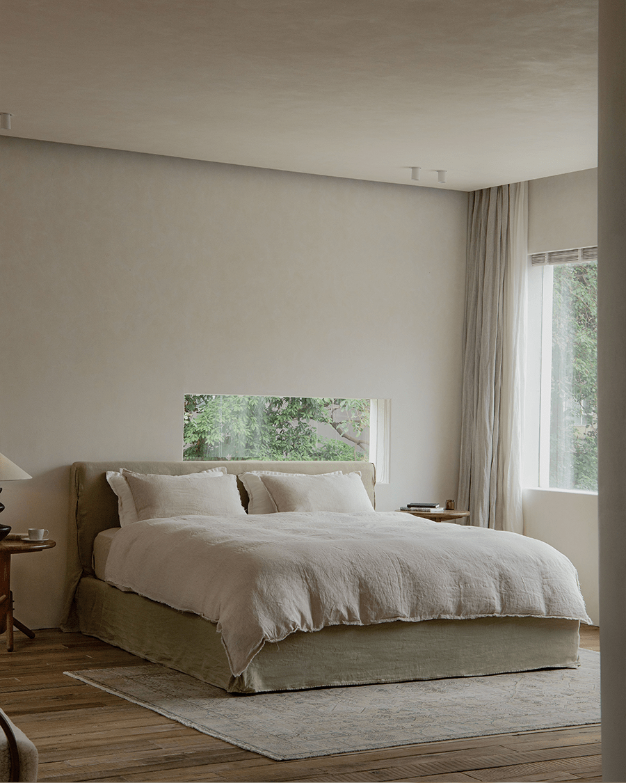 Freya Linen Bed in a modern bedroom, featuring natural linen upholstery and a solid pine frame