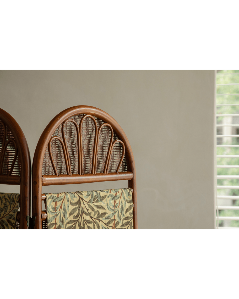 GeTan natural rattan room divider panel with arched weave and willow leaf fabric.