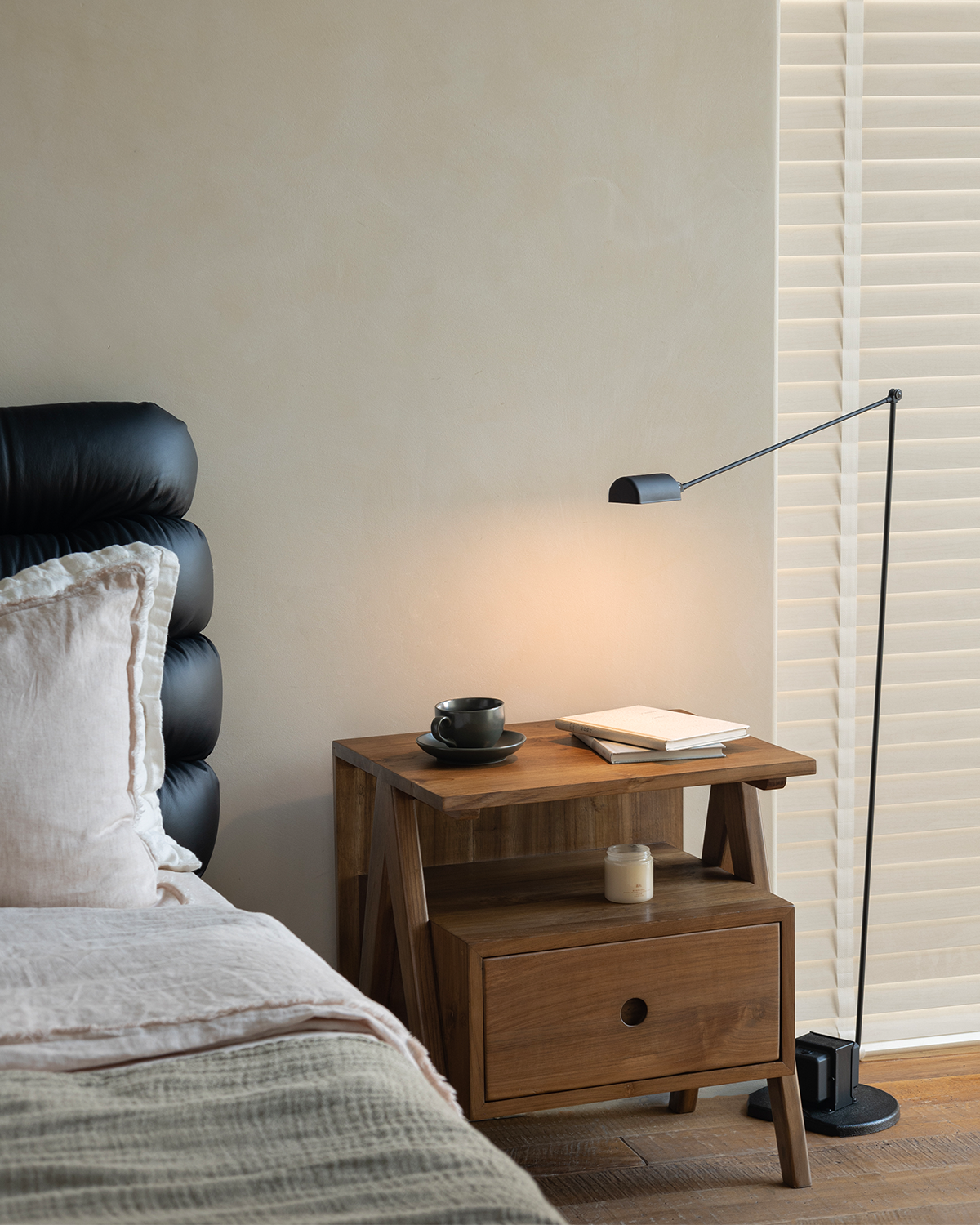 ZM Home Astral Nightstand in bedroom setting with lamp, books and coffee. Modern wooden bedside table