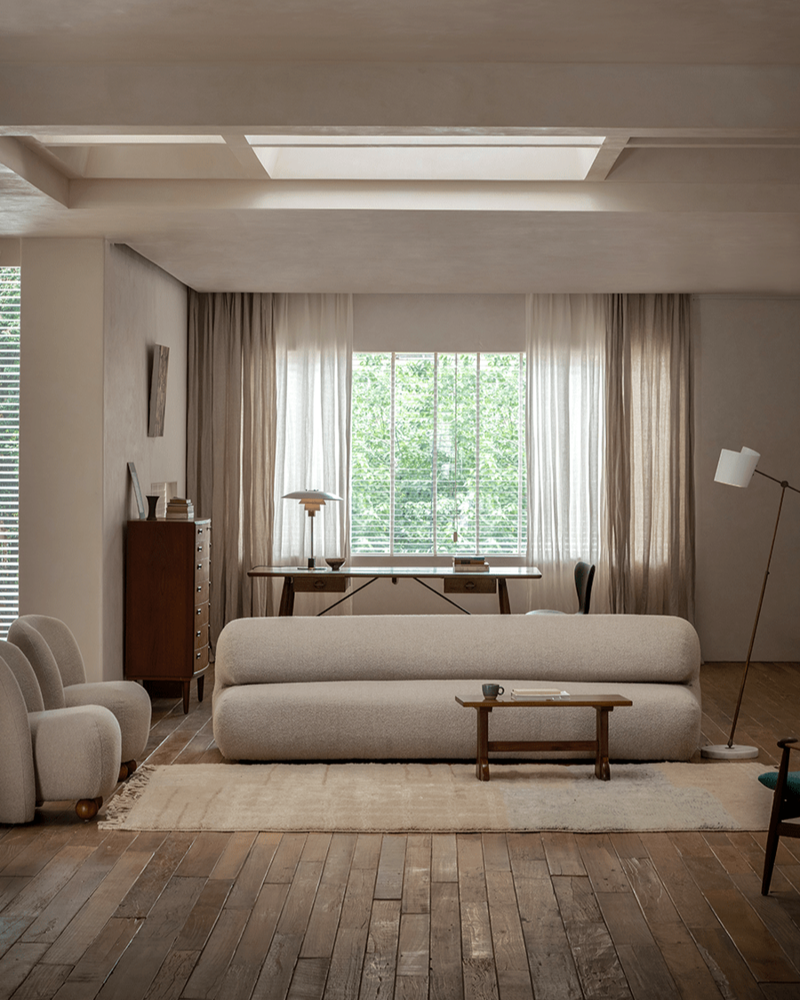 Wave Bouclé Sofa in cozy living room setting, featuring soft bouclé fabric, wooden accents and natural light