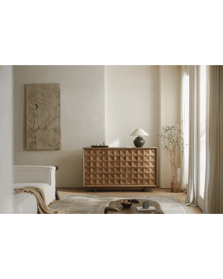 Stylish Bumpy Sideboard with lamp and vase in bright living room decor.