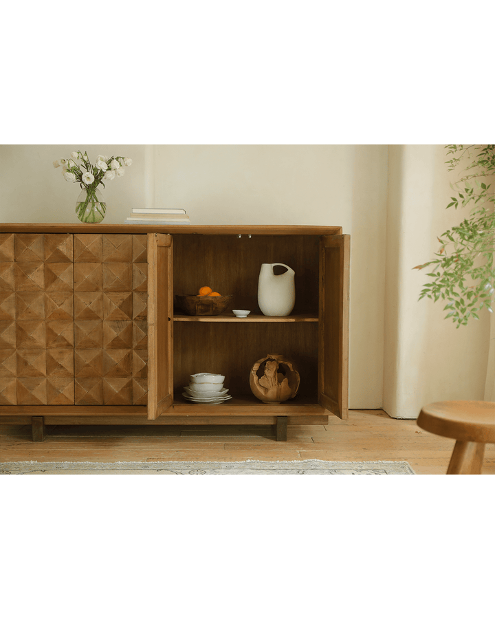 Open Bumpy Sideboard showcasing decorative bowls and tableware in bright room.