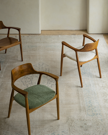 Hiroshima Chair collection, showcasing solid wood frame armchairs with green, white and brown seats for modern living spaces
