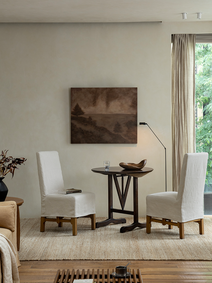Stylish V-Leg Round Table with rustic appeal in a cozy living space setting