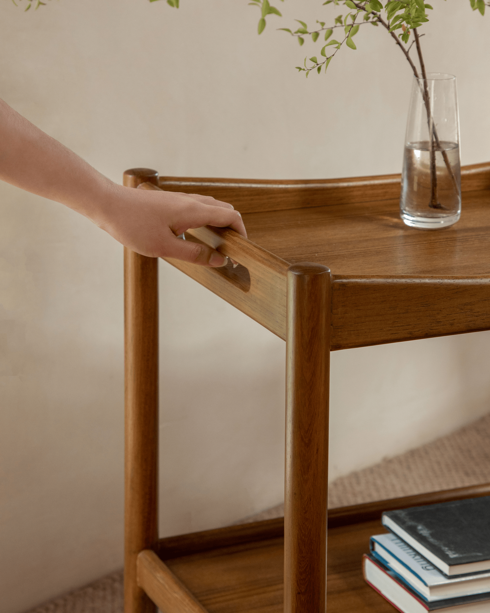 Brooklyn Bar Cart with wooden handle detail, double-layer storage, and a vase.