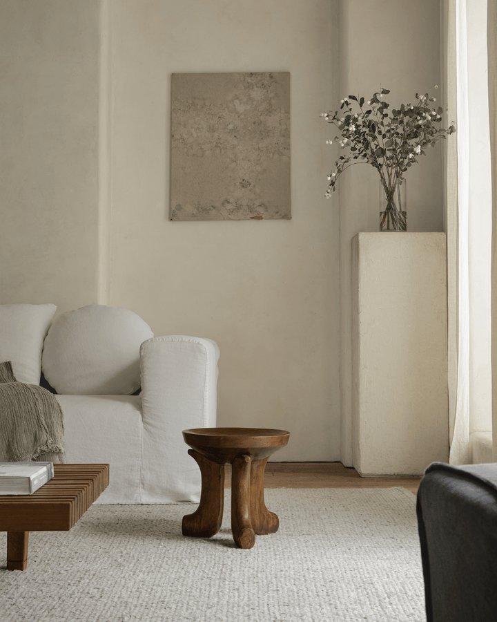 Handcrafted wooden Quincy stool in a stylish, light living room setting