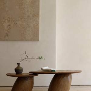 Alva Side Table in natural wood. Playful, organic design with a vase and a book.