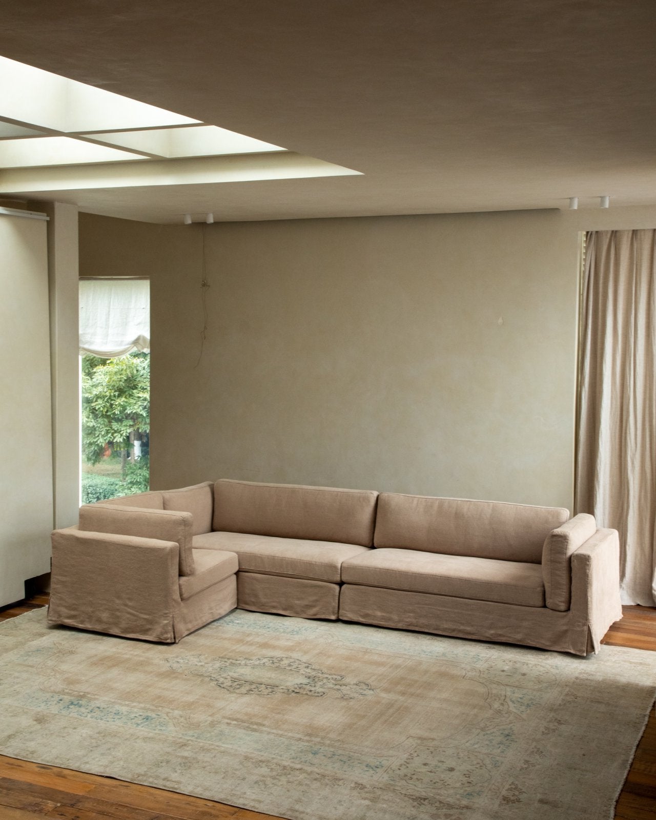 Beige linen Skirt Sectional Sofa in a modern living room, customizable modular design