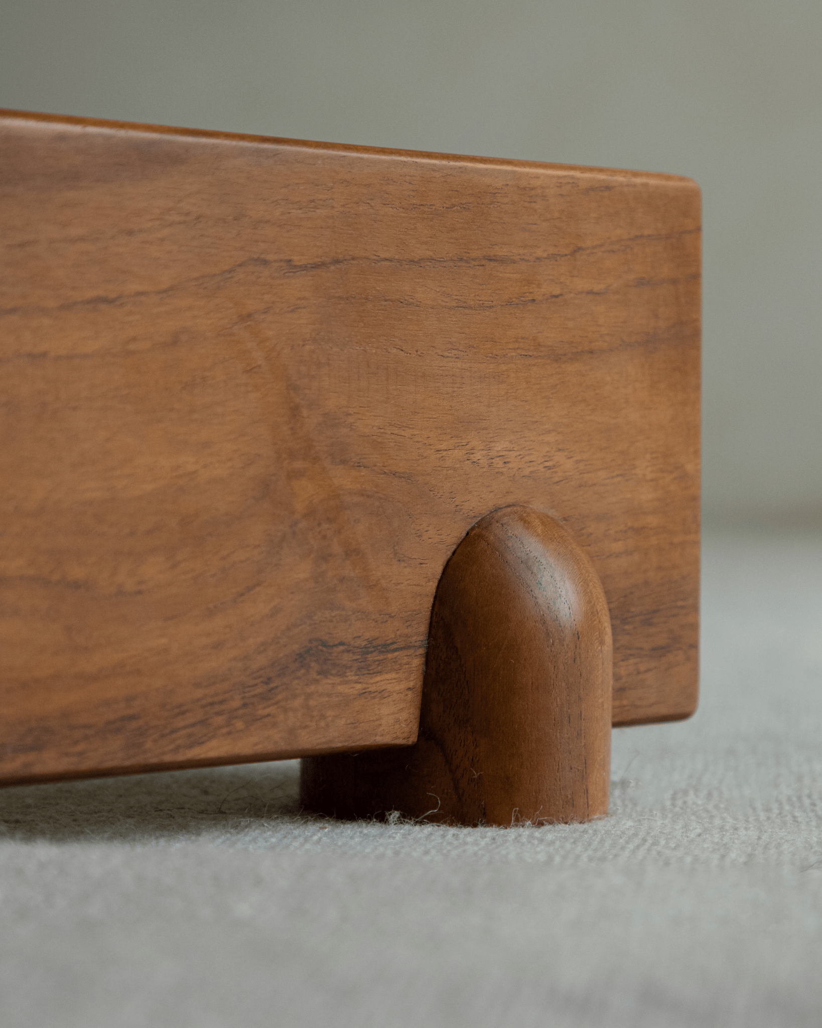 Hoof Dining Table detail: warm brown solid wood tabletop and I-shaped base design for dining.