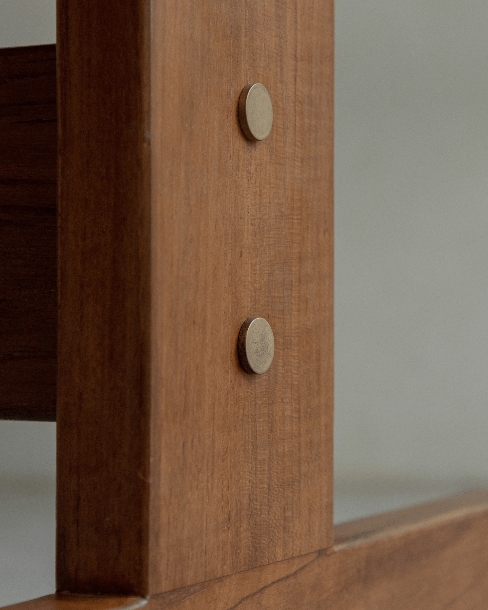 Hoof Dining Table detail: Solid wood leg with metallic accent, showcasing the table's craftsmanship.