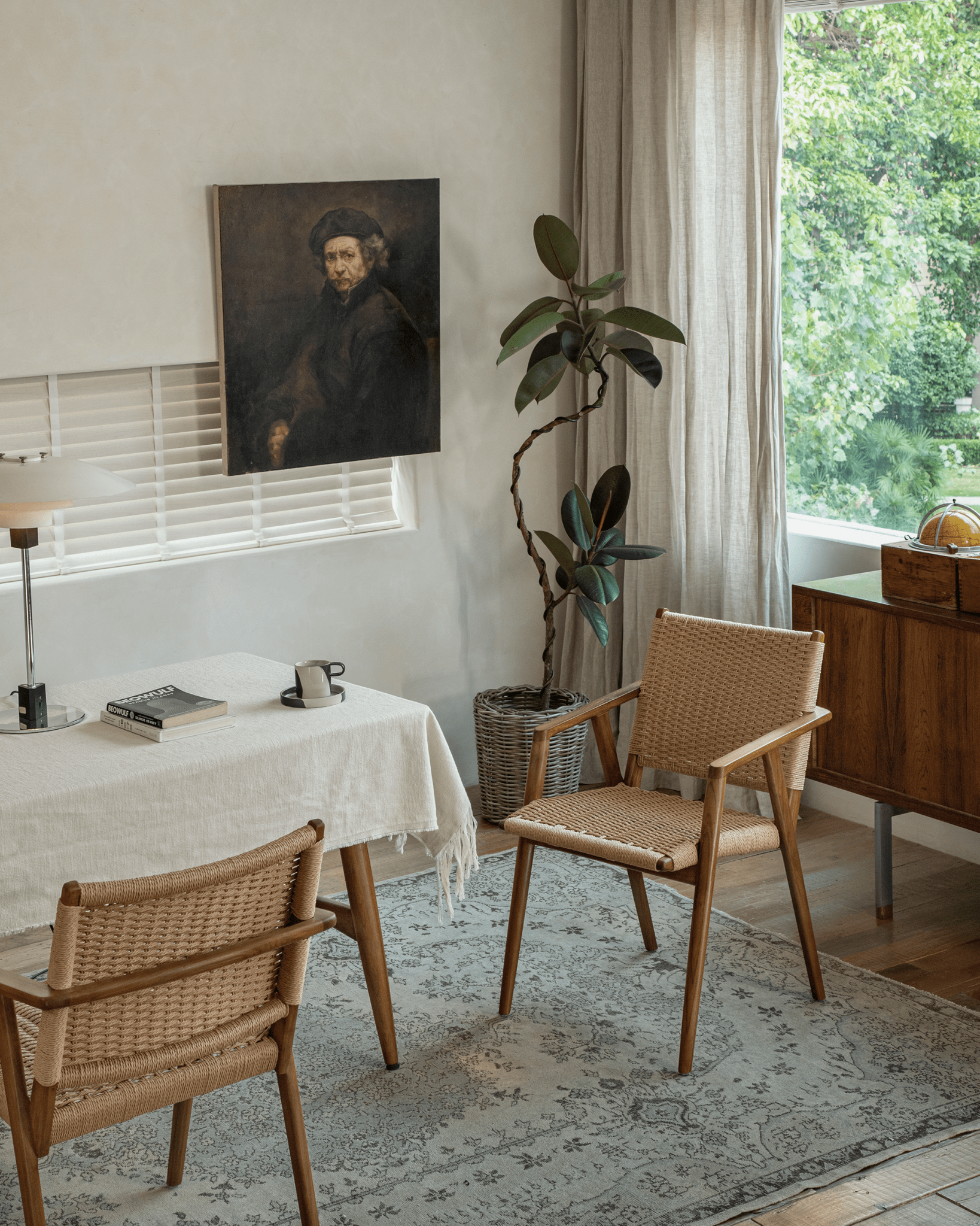 Louisa Chair in a stylish setting. Teak frame and woven seat chairs. Mid-Century Modern design. MCM replica.