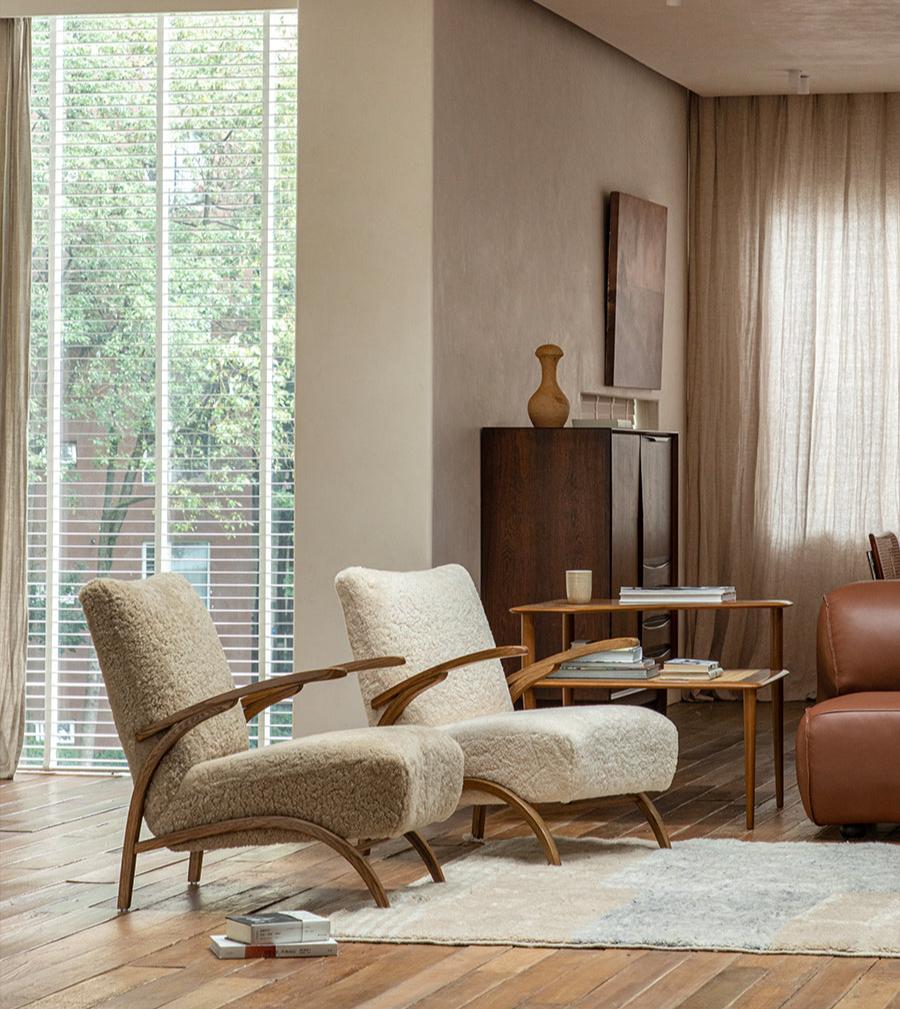 Nebula Lounge Chair in shearling upholstery with red oak frame, mid-century modern living room setting, cozy and comfortable.