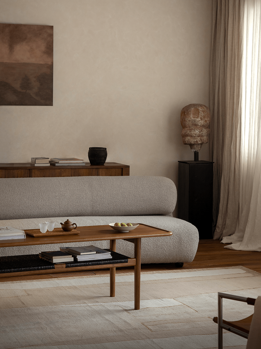 Hans Accent Table in modern living room setting, wooden coffee table with tea set, woven shelf and minimalist decor.