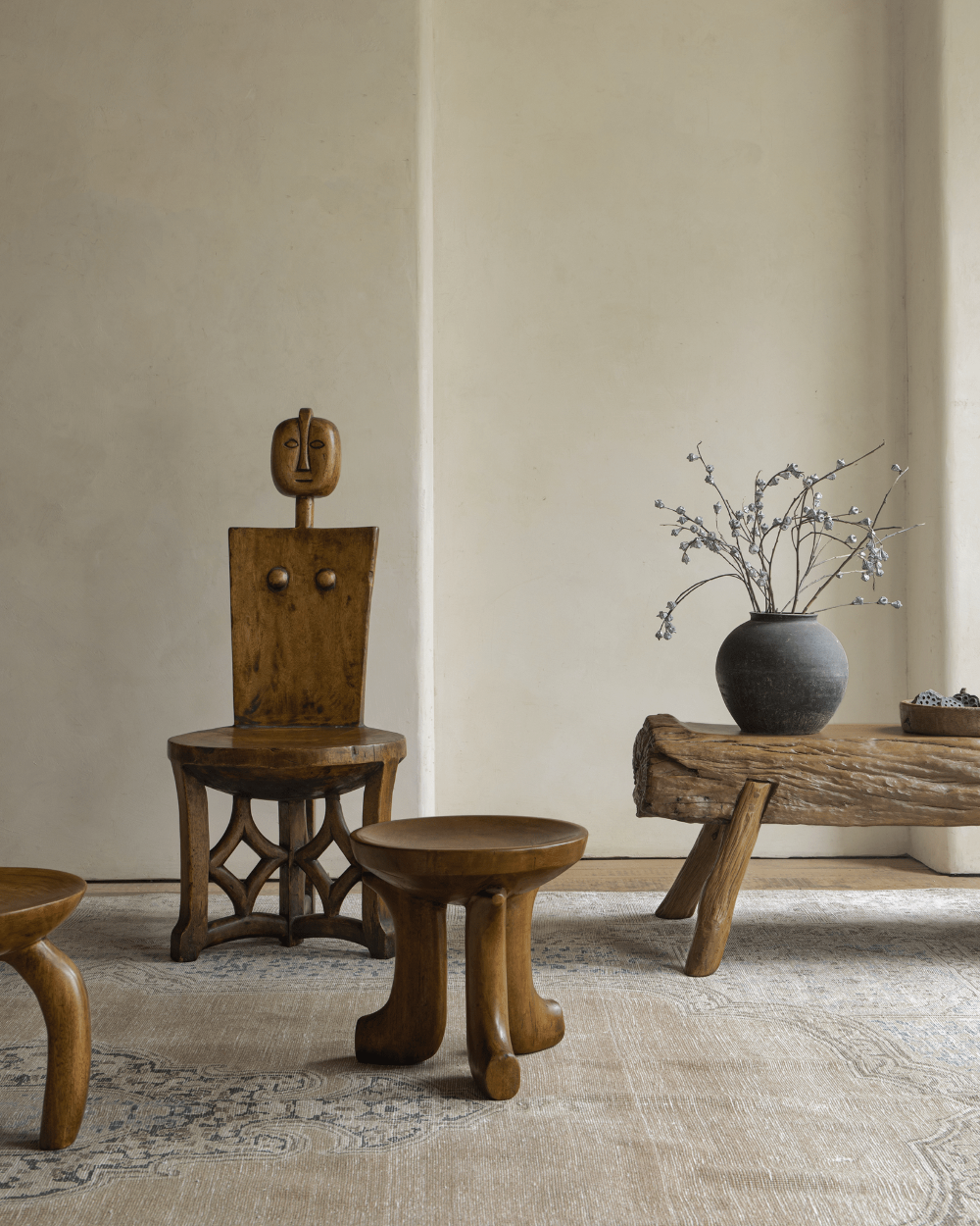 Quincy stool alongside artistic wooden chair and bench, showcasing modern design and natural materials for home decor.