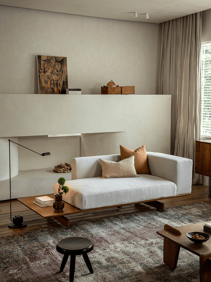 Stylish modular linen sofa with teak base in modern living room setting.