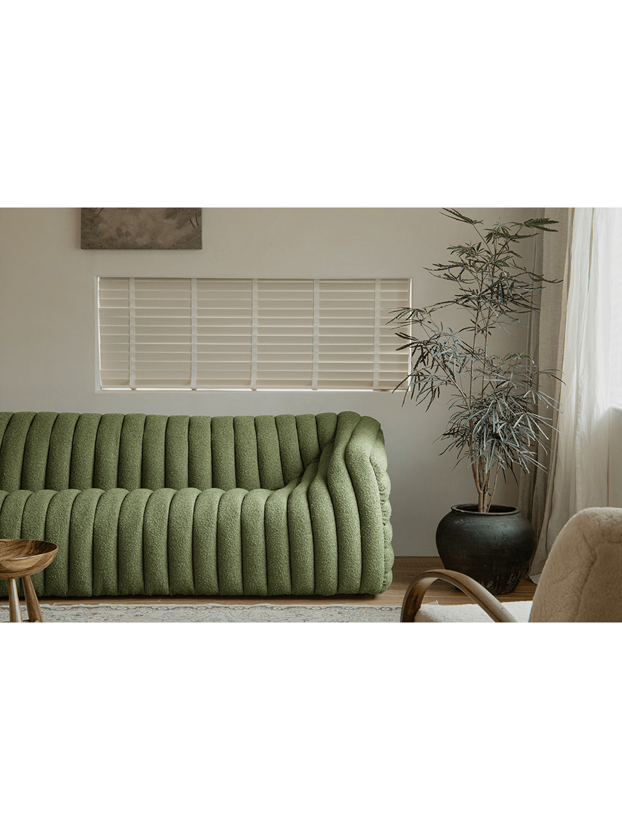 Green Miche Sofa with ribbed design in cozy living room setting, soft fabric, perfect for comfortable living