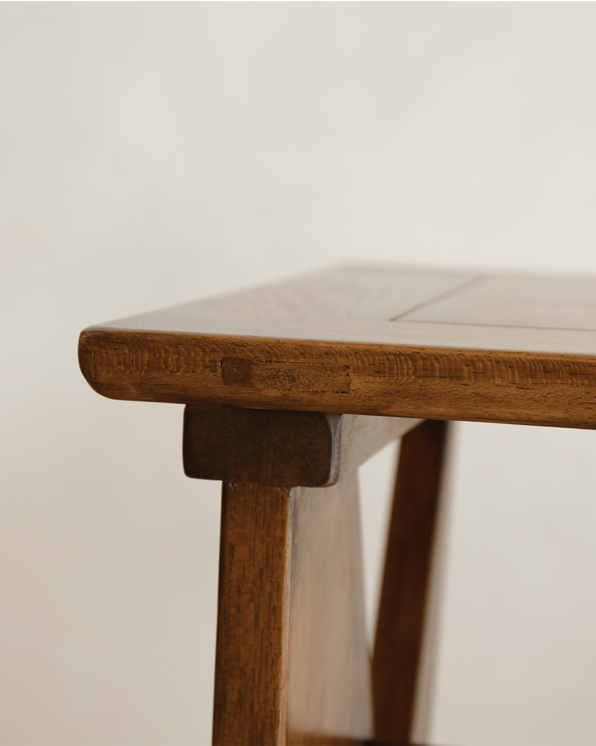 Teak writing desk detail, highlighting wood grain and craftsmanship. Perfect for a home office.