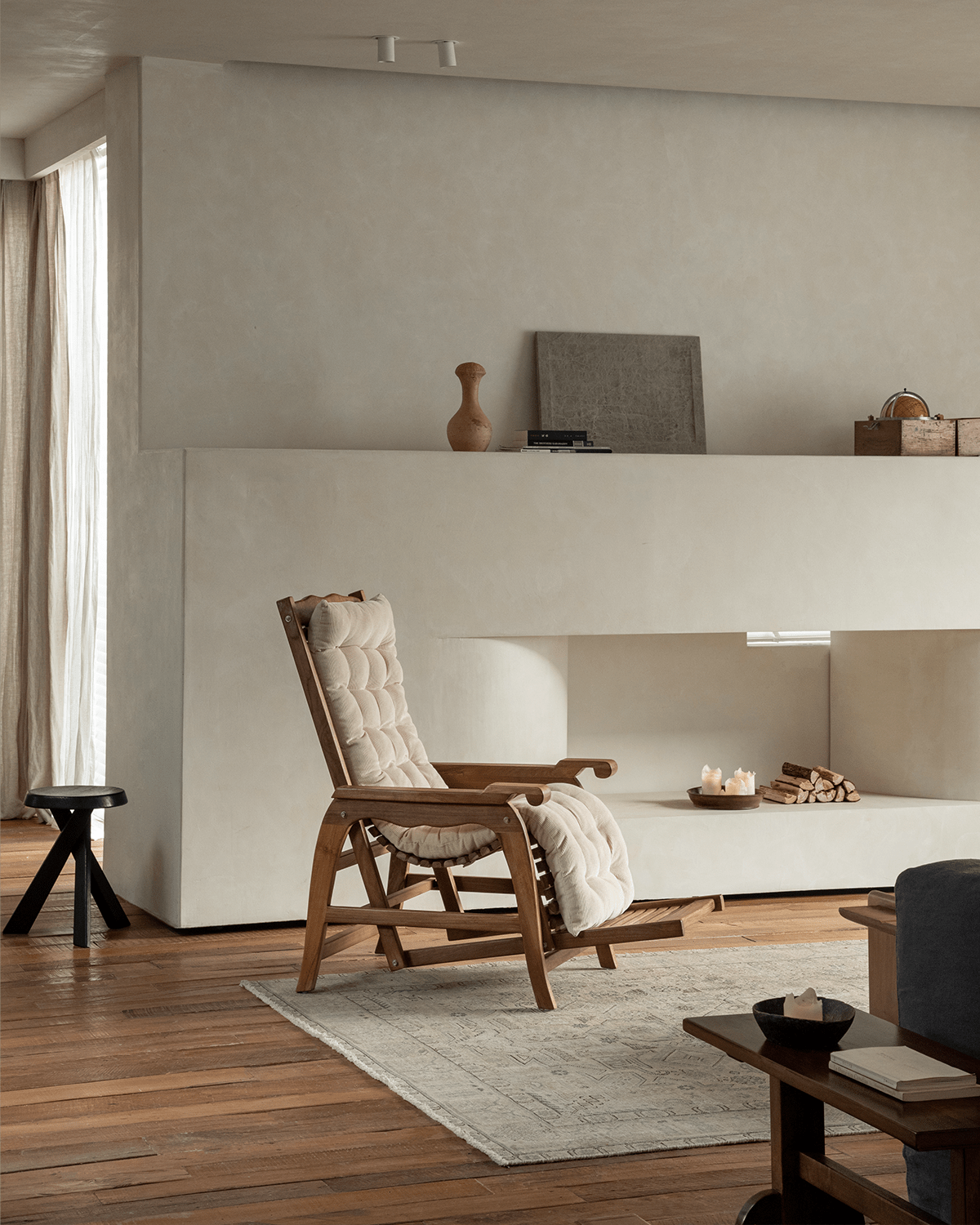 Teak Roller Chaise Lounge with cream cushion in a stylish living room; perfect for relaxation and full-body support