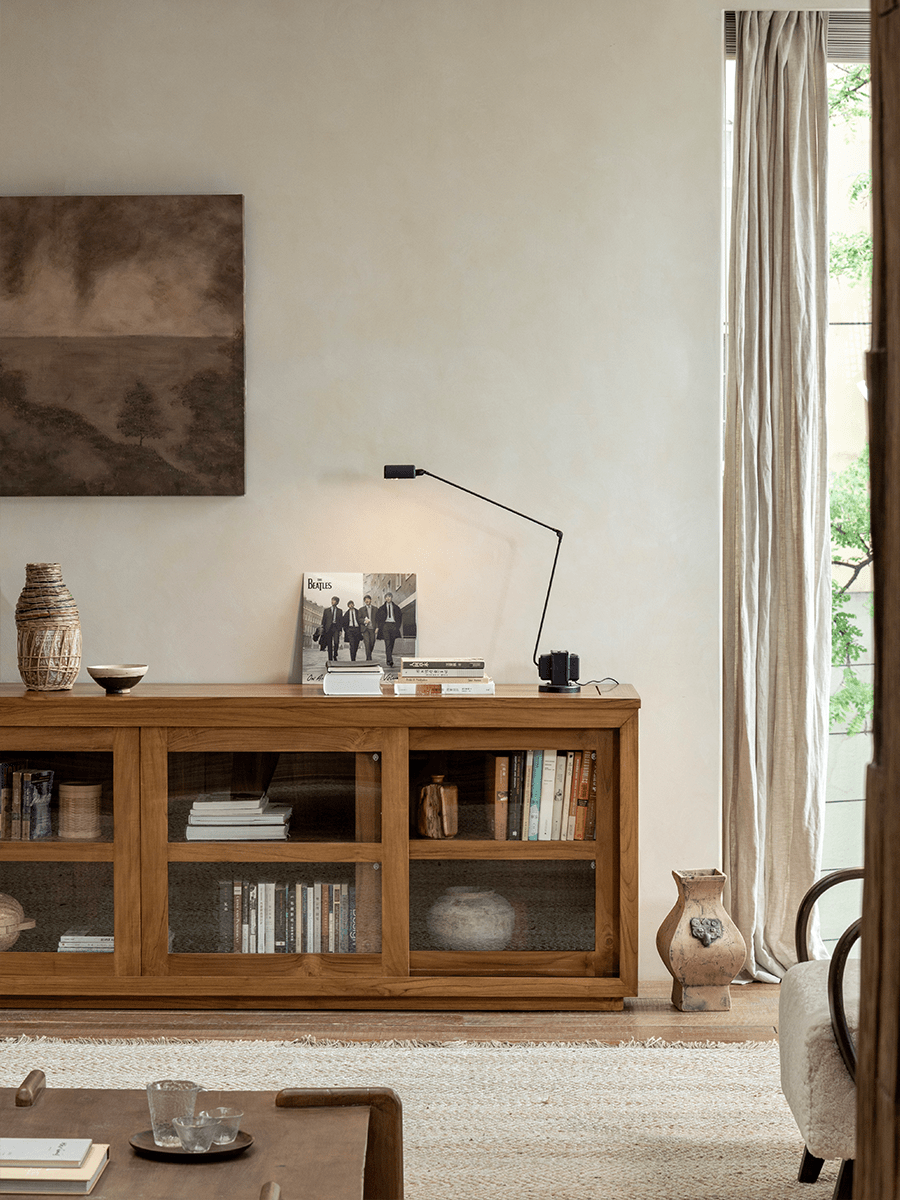 Teak wood glass front bookcase with sliding doors, display books and decor in living room, Beatles album