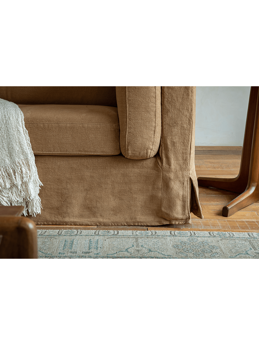Brown Skirt Linen Sofa, modern design with linen fabric, wooden side table, and rug, creates a peaceful atmosphere