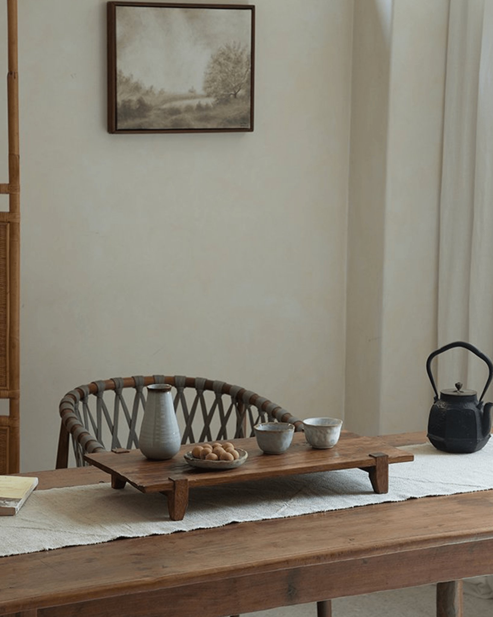 Chinese tea tray with cups, teapot, and snacks on a reclaimed wood table, antique design