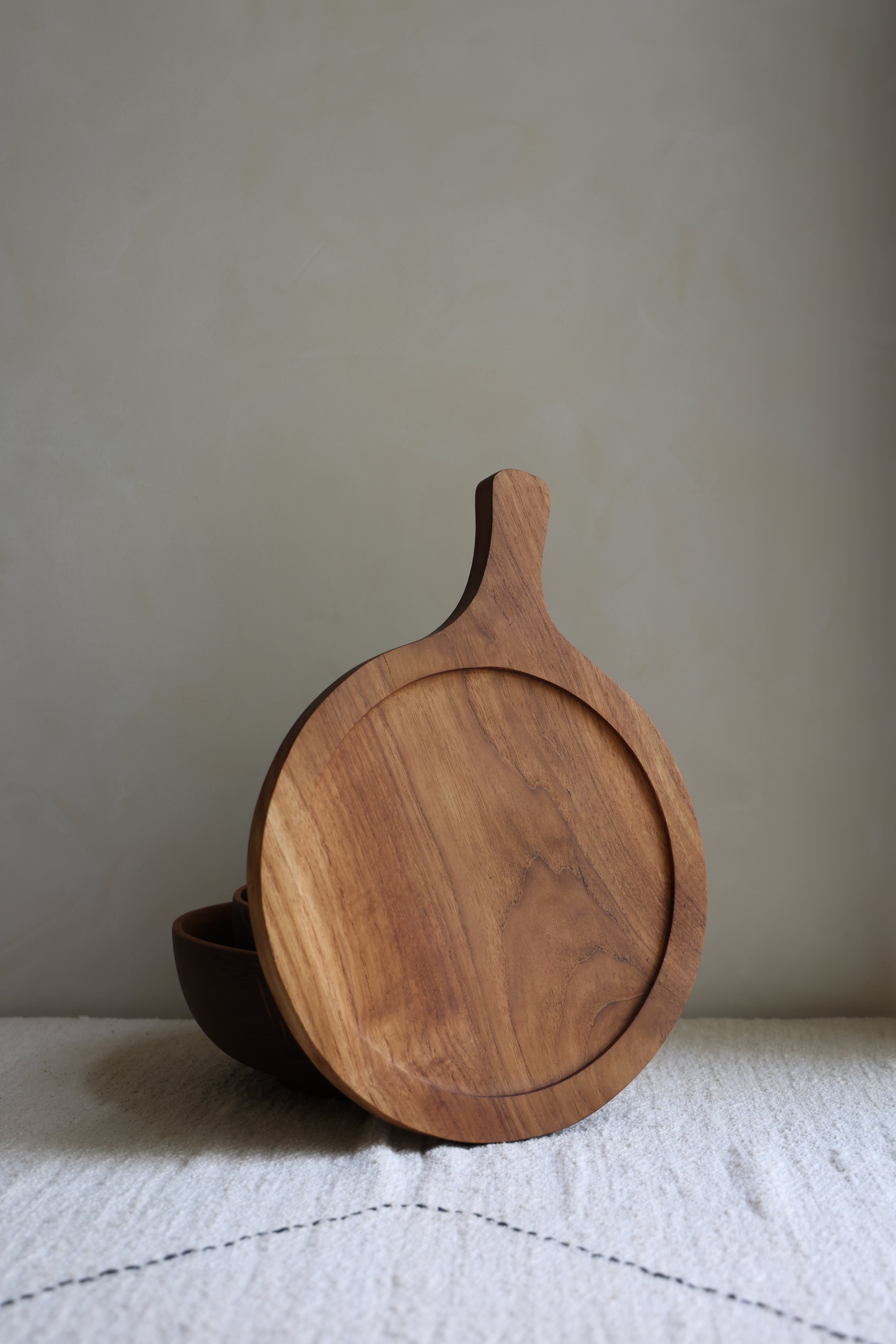 Handcrafted teak wood butcher block with handle, perfect for kitchen chopping and serving