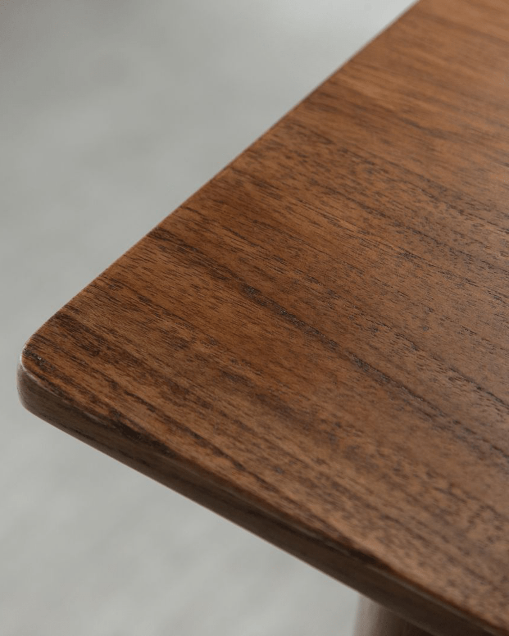 Easy Dining Table detail: African teak wood corner, showing grain and rounded edge for dining