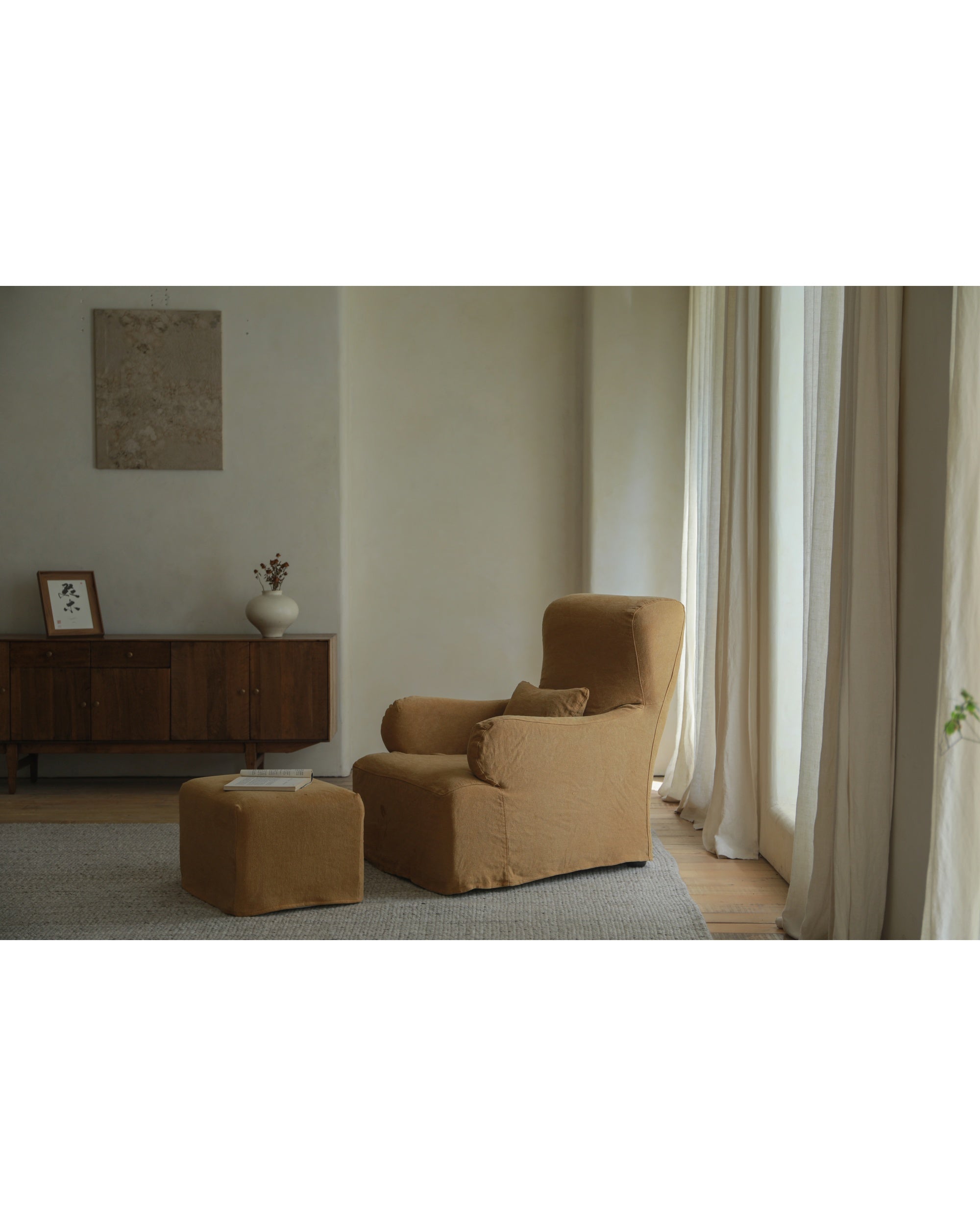 Caramel natural linen Eve Ottoman footrest with matching armchair.