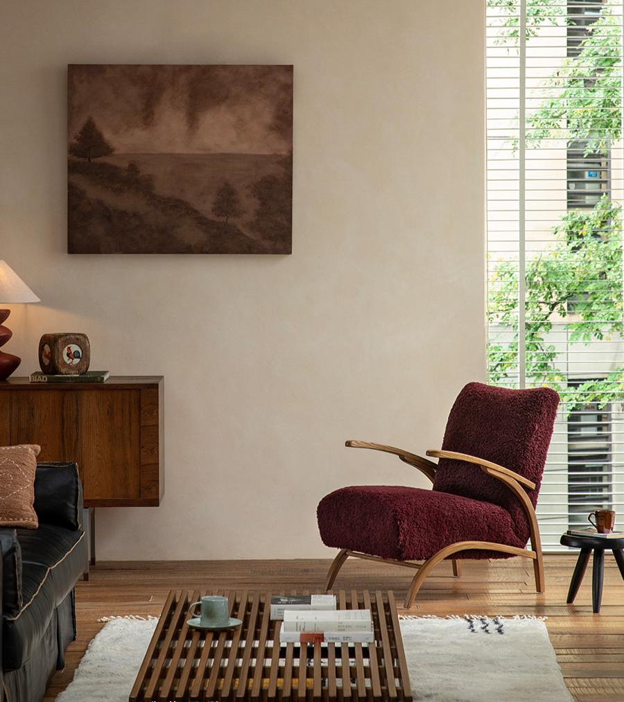 Nebula Lounge Chair - Burgundy shearling and red oak frame, mid-century design in a cozy interior.