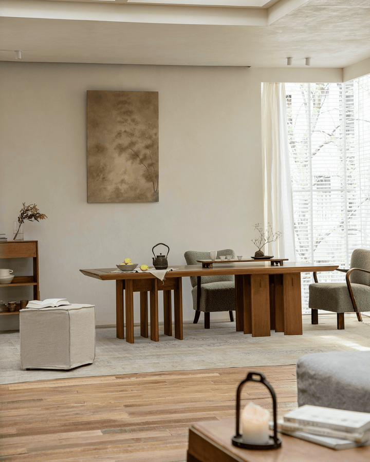 Stylish wooden dining area with Titan Table, ottoman, and green sofa chairs in bright natural light