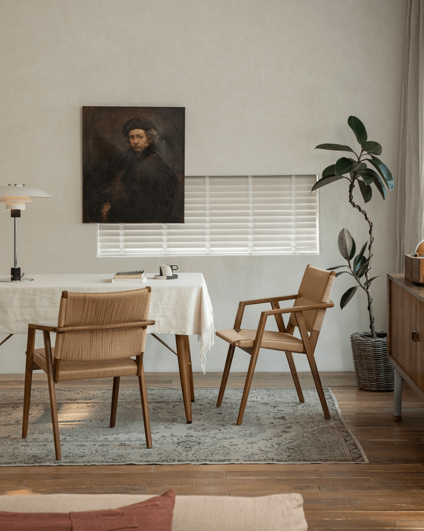 Louisa Chair dining setting. Teak frame, woven seat chairs. MCM design in stylish room setting.