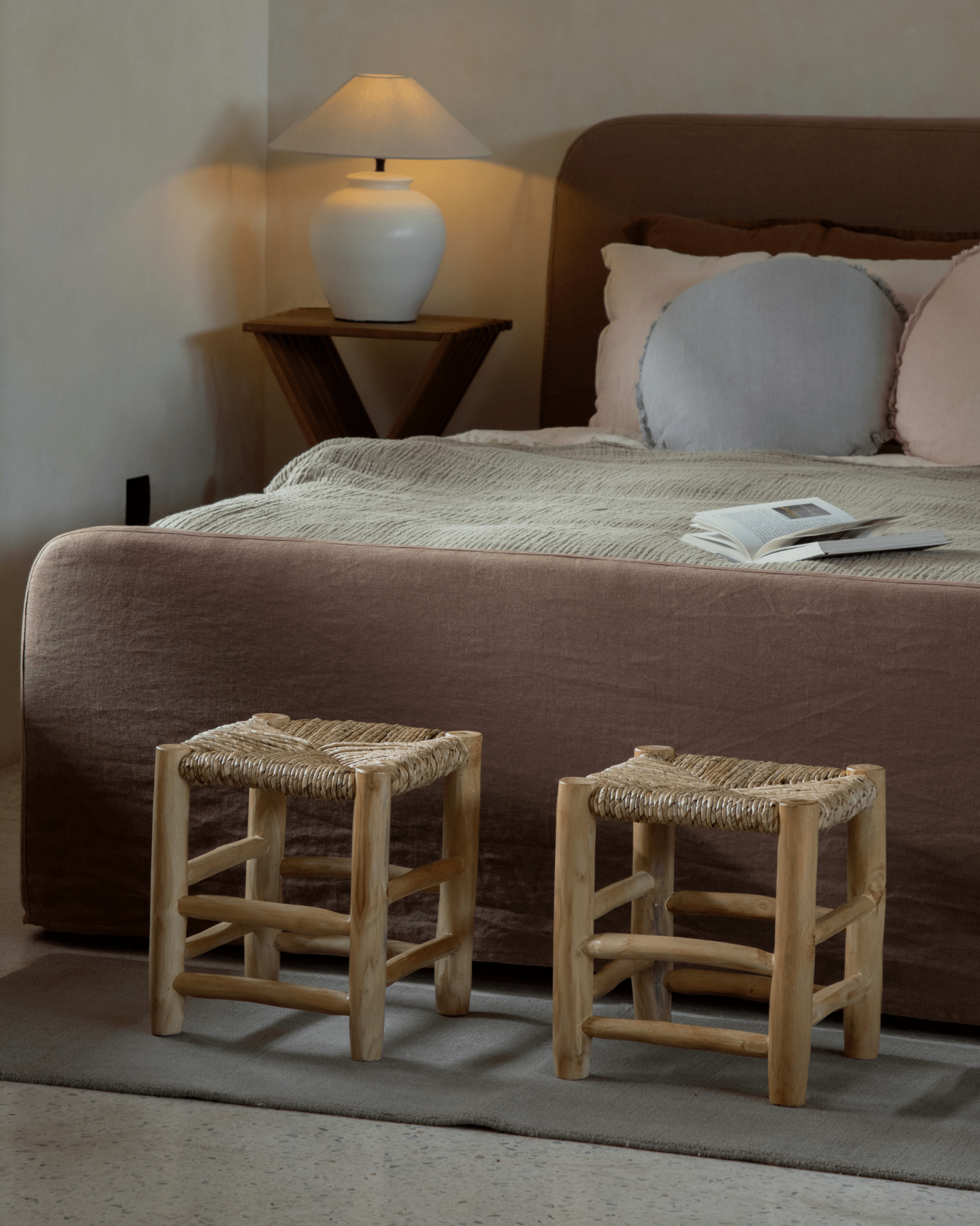 Isla Handwoven Stool set, showcasing natural wood frames with woven seat in a modern bedroom setting