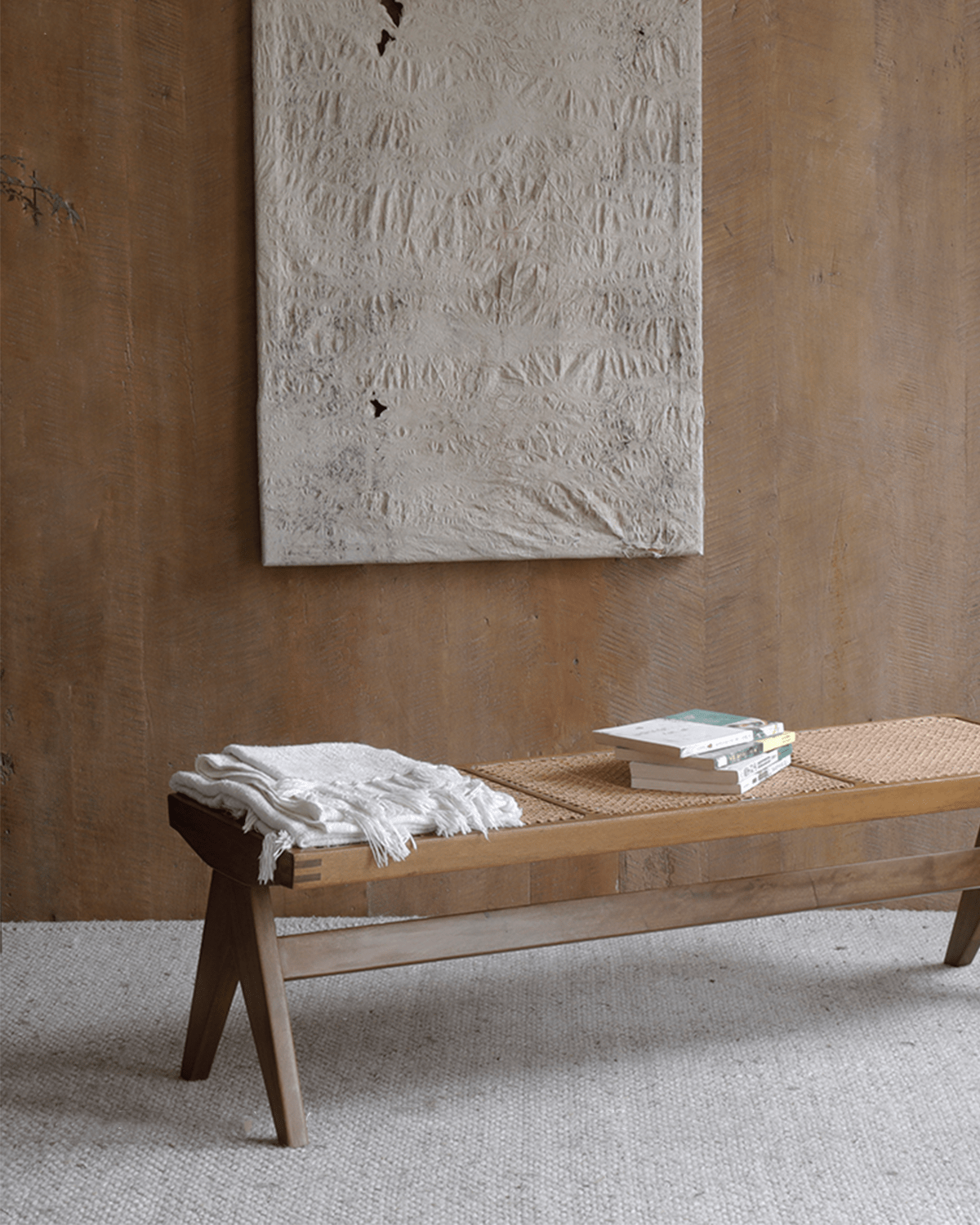 Chandigarh bench with teak wood and natural rattan, mid-century modern design, interior setting with decor