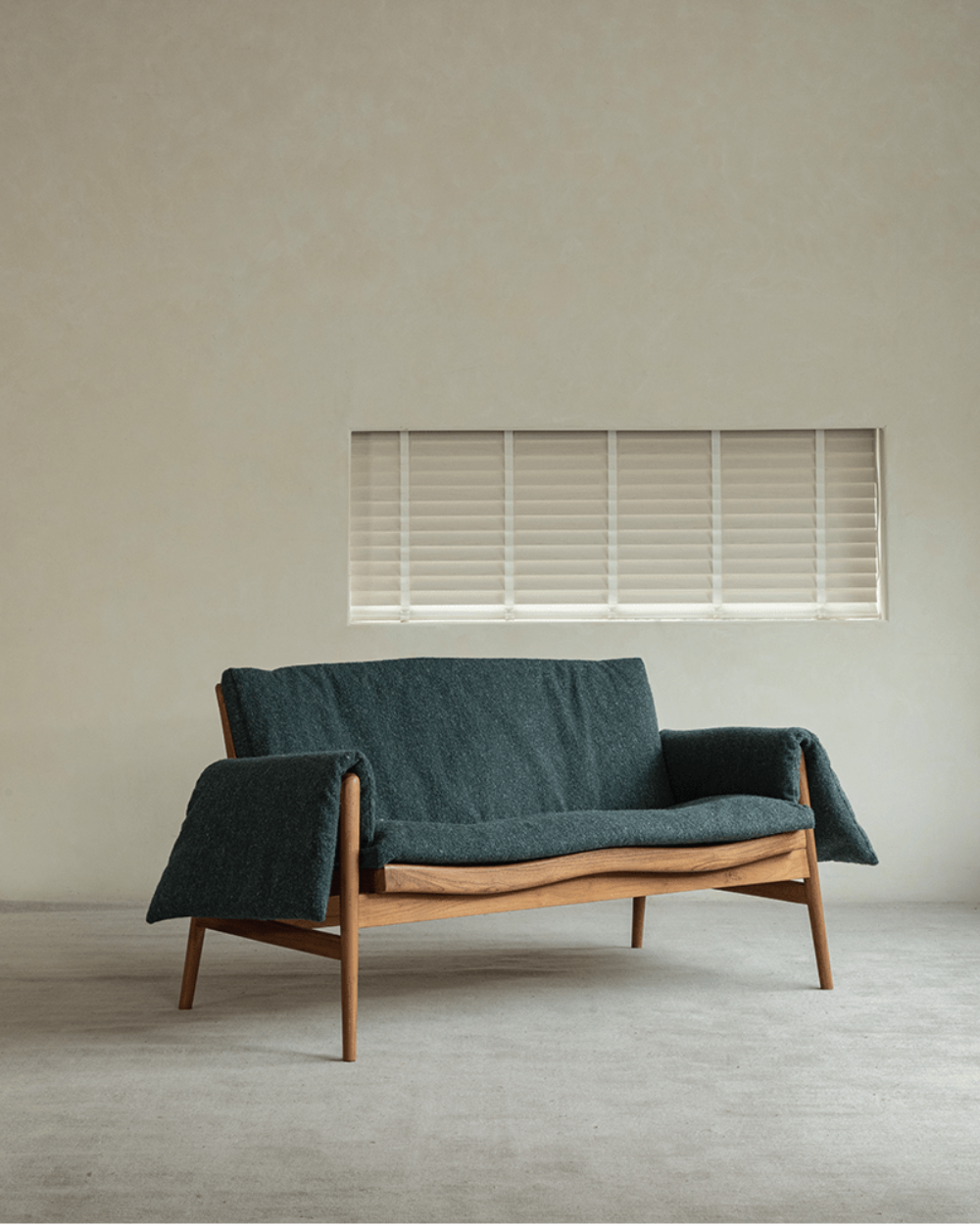 Teak wood garden lounge chair with teal cushion and blanket, perfect for indoor or outdoor use