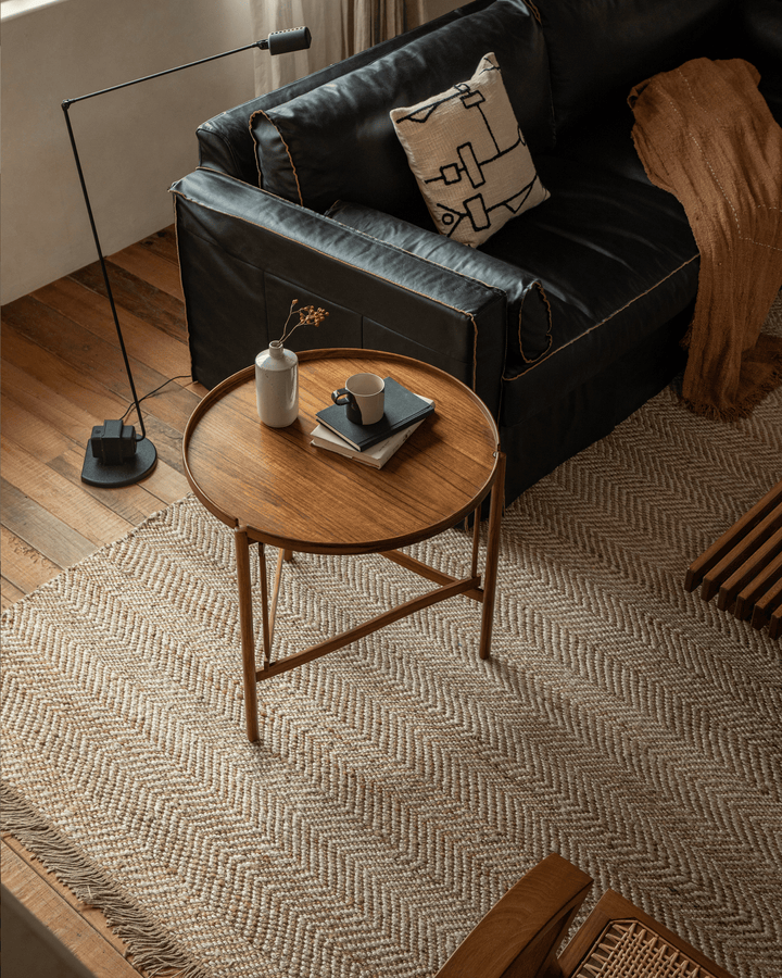 Hansen Tray Side Table styled with vase and cup in modern living room with cozy decor.