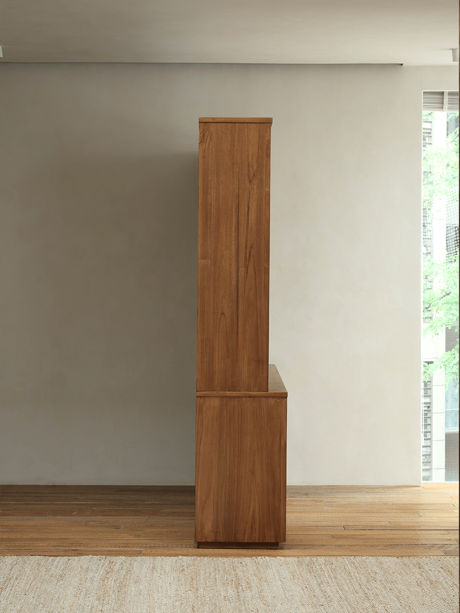 Teak wood glass front bookcase, side view showcasing the rich wood grain and elegant design, ideal for storage.