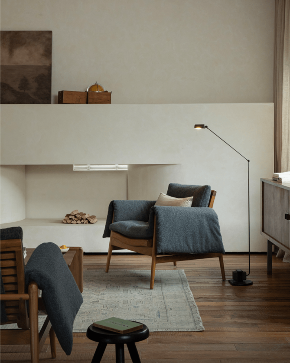 Modern teak wood garden lounge chair with dark grey cushion and blanket in a stylish interior, modern design