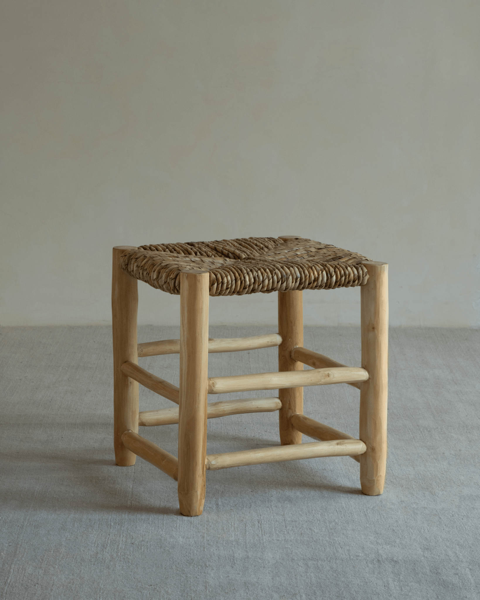 Isla Handwoven Stool with teak frame and pandan leaf seat. Natural, modern, and handcrafted for any space.
