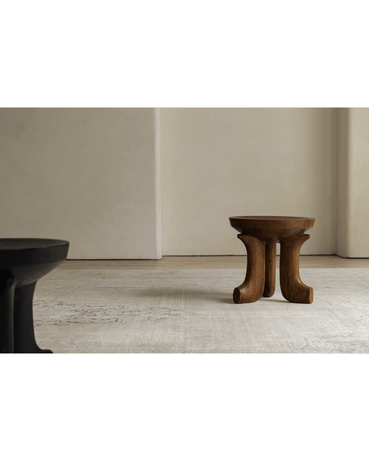 Black and wooden Quincy stools in a minimalist decor setting