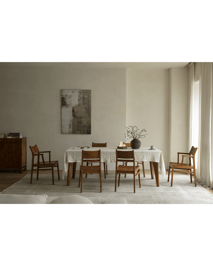 Elegant dining room with a wooden table, six wooden chairs, and minimalist decor.